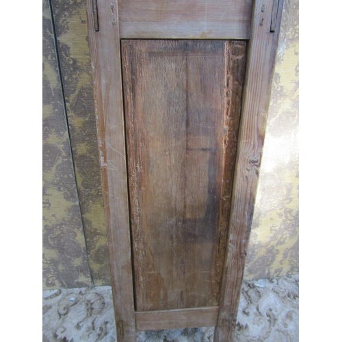 1130 - A tall narrow antique stained pine cupboard enclosed by a triple paneled door raised on turned suppo... 