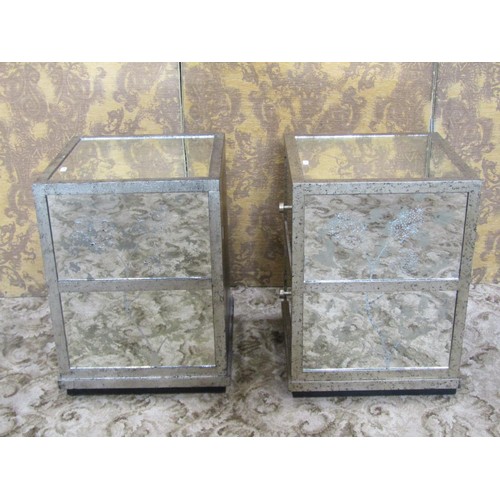 1132 - A pair of low contemporary two drawer bedside chests with mirrored panels and silvered frames, 54 cm... 