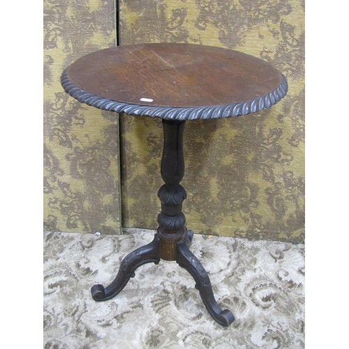 1134 - A Victorian oak occasional table, the circular top with gadroon border raised on a turned pillar and... 