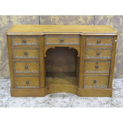 1142 - A Victorian pine shallow inverted breakfront dressing table/desk fitted with an arrangement of nine ... 