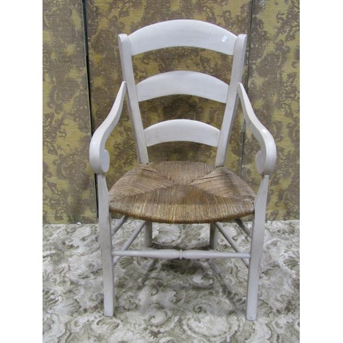 1147 - A French provincial open elbow chair with rush seat, tapered ladderback, open scrolled arms and pain... 