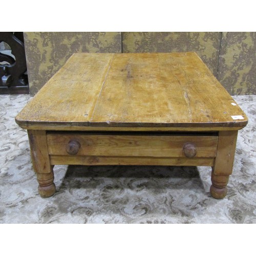 1149 - A Victorian low stripped pine table of rectangular form with frieze drawer raised on turned supports... 