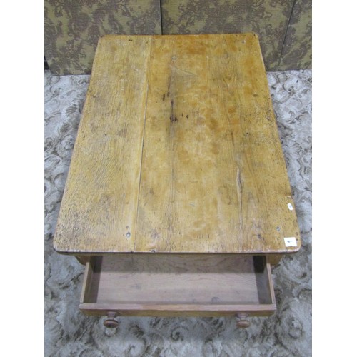 1149 - A Victorian low stripped pine table of rectangular form with frieze drawer raised on turned supports... 