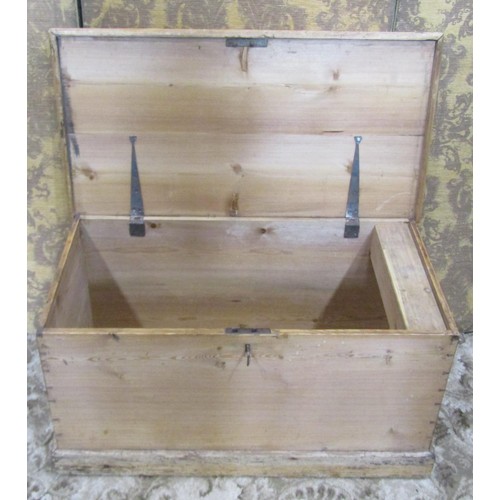 1153 - A 19th century stripped pine blanket box with hinged lid, exposed dovetail construction and drop sid... 