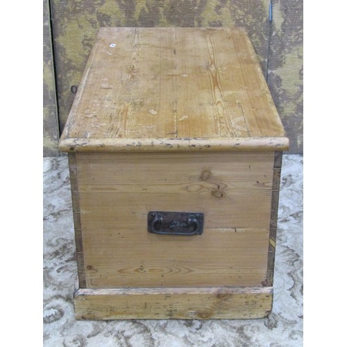 1153 - A 19th century stripped pine blanket box with hinged lid, exposed dovetail construction and drop sid... 