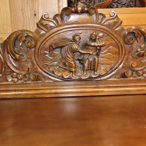 1169 - A continental walnut buffet with raised back over a pair of panelled doors with carved, mask cornuco... 