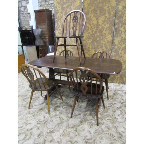 1181 - A vintage Ercol dark stained elm refectory table together with a set of six associated Ercol hoop an... 