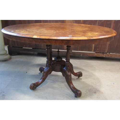 1215 - A Victorian figured and burr walnut veneered tilt top breakfast table of oval form with inlaid detai... 