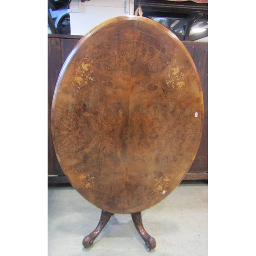 1215 - A Victorian figured and burr walnut veneered tilt top breakfast table of oval form with inlaid detai... 