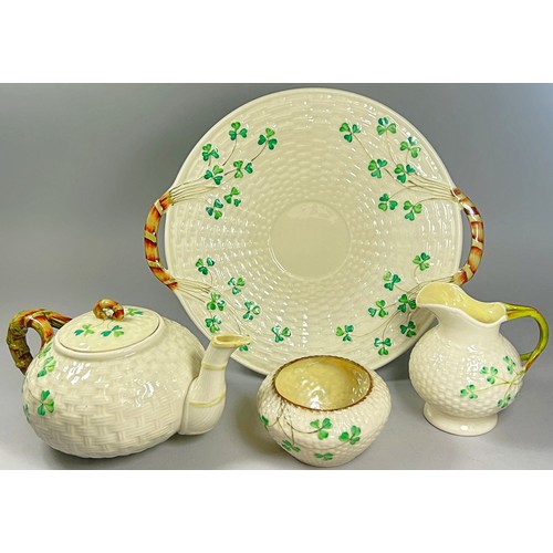 52 - A collection of Belleek porcelain items to include shamrock pattern tea wares, teapots, sugar bowls,... 