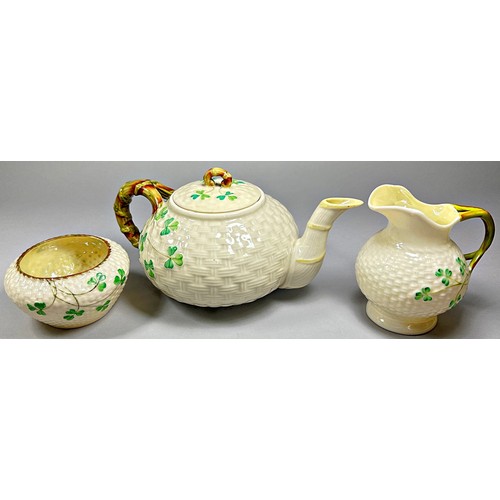 52 - A collection of Belleek porcelain items to include shamrock pattern tea wares, teapots, sugar bowls,... 