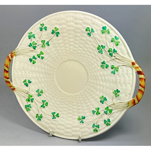 52 - A collection of Belleek porcelain items to include shamrock pattern tea wares, teapots, sugar bowls,... 