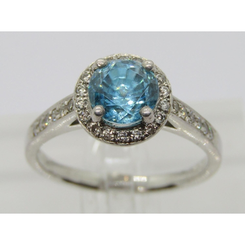 347 - 950 platinum blue topaz and diamond halo cluster ring, the diamonds 0.02ct each approx, maker 'XM', ... 