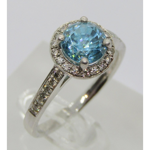 347 - 950 platinum blue topaz and diamond halo cluster ring, the diamonds 0.02ct each approx, maker 'XM', ... 