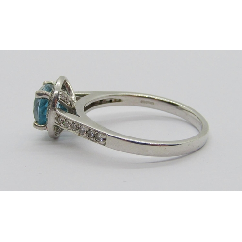 347 - 950 platinum blue topaz and diamond halo cluster ring, the diamonds 0.02ct each approx, maker 'XM', ... 