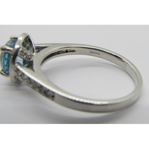 347 - 950 platinum blue topaz and diamond halo cluster ring, the diamonds 0.02ct each approx, maker 'XM', ... 