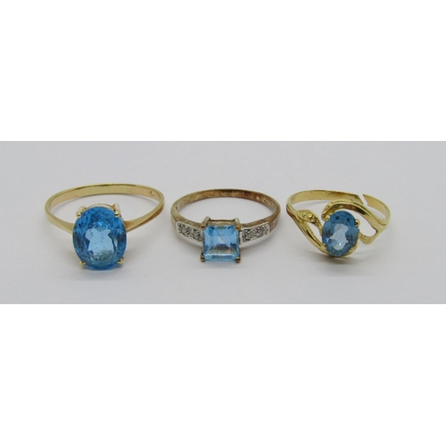 349 - Three blue topaz dress rings; a 14ct oval example, size V, a 9ct square-cut example with diamond set... 