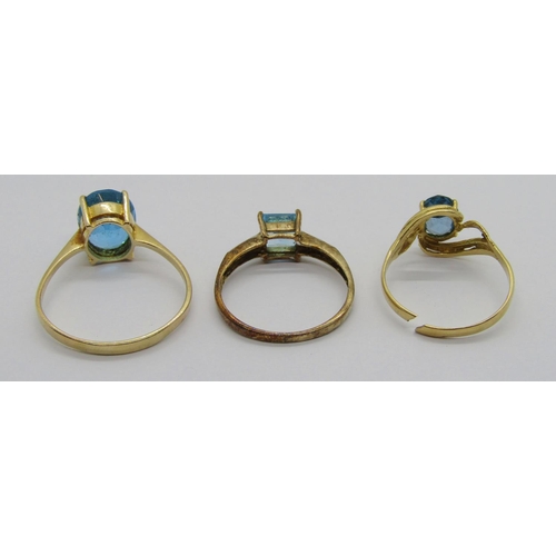 349 - Three blue topaz dress rings; a 14ct oval example, size V, a 9ct square-cut example with diamond set... 