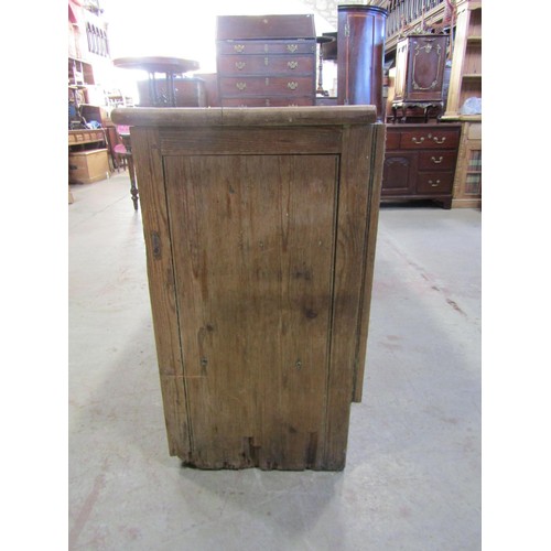 1189 - A Victorian stripped pine kitchen dresser base enclosed by four panelled doors beneath three frieze ... 