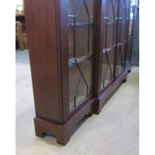 1190 - A Georgian mahogany breakfront bookcase/display cabinet enclosed by four astragal glazed panelled do... 