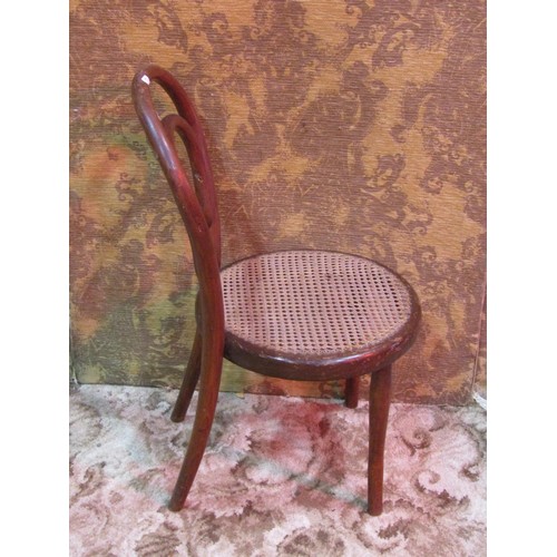 1257 - A vintage child's bentwood chair with circular cane panelled seat