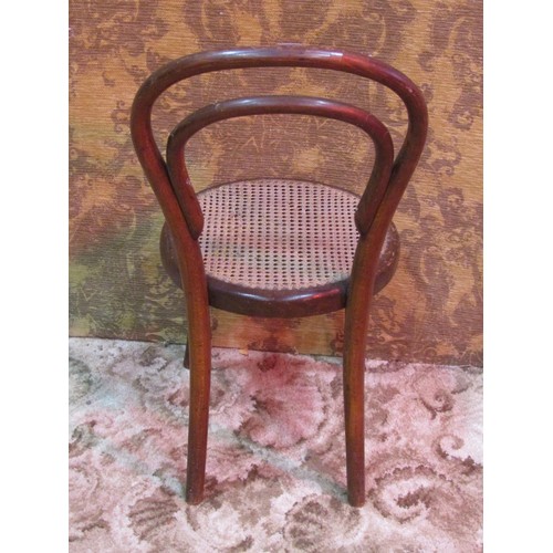 1257 - A vintage child's bentwood chair with circular cane panelled seat