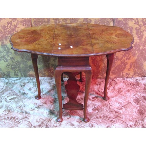 1194 - A figured walnut veneered drop leaf gateleg occasional table, the top with serpentine moulded outlin... 