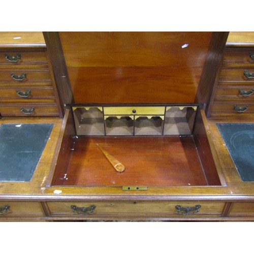 1259 - An Edwardian walnut kneehole twin pedestal Dickens type desk fitted with an arrangement of drawers, ... 