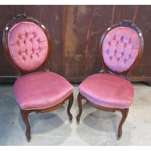 1198 - A pair of Victorian chairs with upholstered seats and buttoned cameo shaped backs within walnut show... 