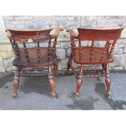 1270 - Two similar late 19th century elm and beechwood smokers bow chairs with turned spindle backs and sad... 