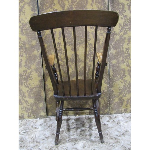 1274 - A Windsor stained elm and beechwood stick back armchair with saddle shaped seat