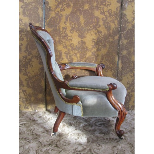 1276 - A Victorian drawing room chair with upholstered seat and button back with show wood frame