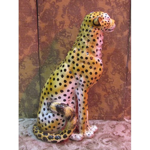 1282 - A life-sized glazed ceramic ornament in the form of a seated cheetah, 92cm high