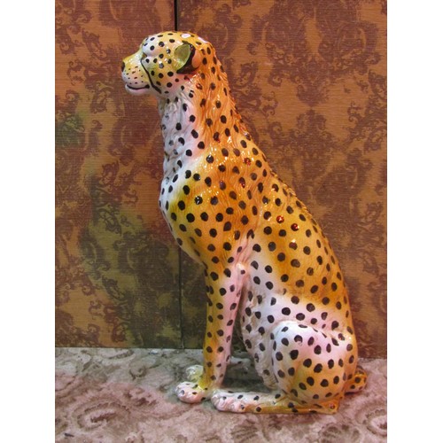 1282 - A life-sized glazed ceramic ornament in the form of a seated cheetah, 92cm high