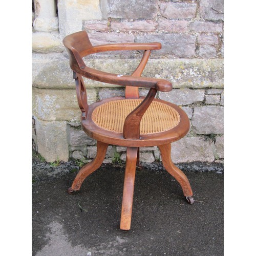 1288 - A late Victorian swivel office chair with pierced splat and cane panelled seat