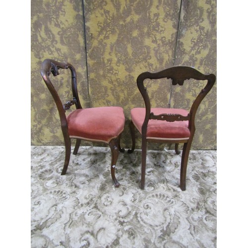 1289 - A set of four Victorian rosewood dining chairs with carved splats, upholstered seats and scrolled ca... 