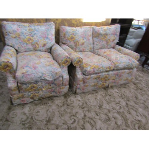 1294 - A traditional two seat sofa and matching armchair with rolled arms, floral printed upholstery with l... 