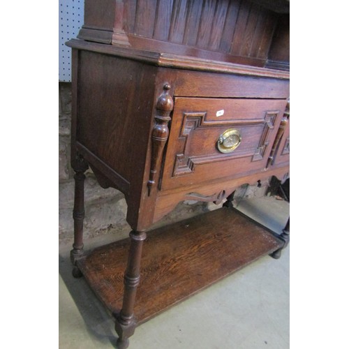 1308 - A small oak cottage dresser in the Jacobean style, with open plate rack over two drawers, on turned ... 