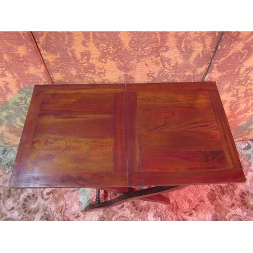 1309 - A reproduction mahogany coaching table raised on folding X framed supports, 69cm high x 82cm x 46cm