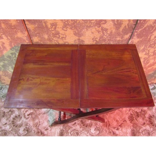 1309 - A reproduction mahogany coaching table raised on folding X framed supports, 69cm high x 82cm x 46cm