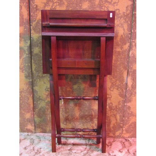 1309 - A reproduction mahogany coaching table raised on folding X framed supports, 69cm high x 82cm x 46cm