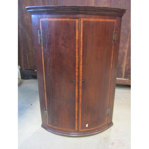 1218 - A Georgian mahogany bureau, the fall flap enclosing a partially fitted interior of small drawers and... 