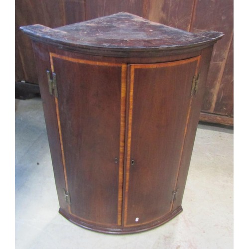 1218 - A Georgian mahogany bureau, the fall flap enclosing a partially fitted interior of small drawers and... 