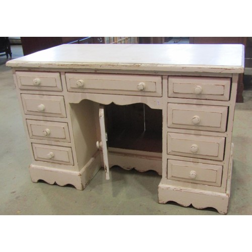 1219 - A  pine kneehole desk fitted with an arrangement of nine drawers flanking a recessed cupboard with a... 