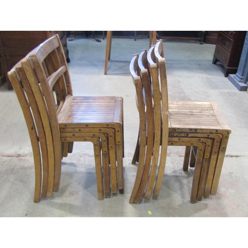 1314 - Eleven vintage wooden stacking chairs with simple rail backs