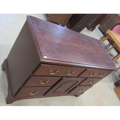 1222 - A Georgian oak dresser base enclosed by an arrangement of six drawers flanking a cupboard enclosed b... 