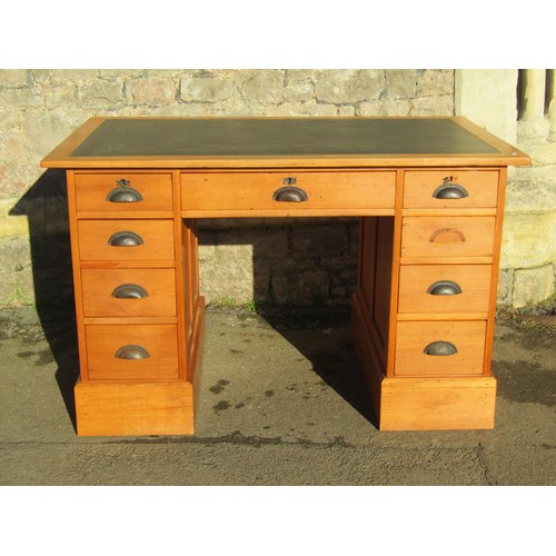 1319 - A vintage satinwood kneehole twin pedestal desk fitted with an arrangement of nine drawers beneath a... 