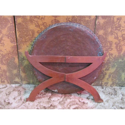 1325 - A large eastern circular copper tray top occasional table raised on a simple folding wooden stand, 7... 