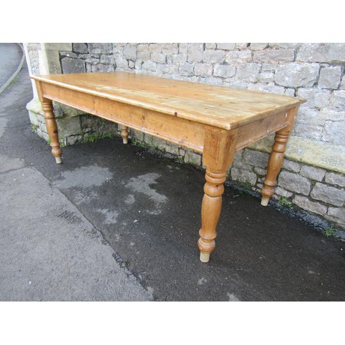 1334 - A Victorian style stripped pine kitchen table raised on turned supports, 76cm high x 183cm x 90cm