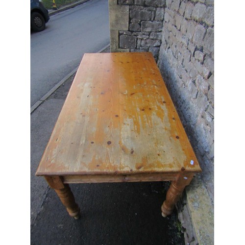 1334 - A Victorian style stripped pine kitchen table raised on turned supports, 76cm high x 183cm x 90cm